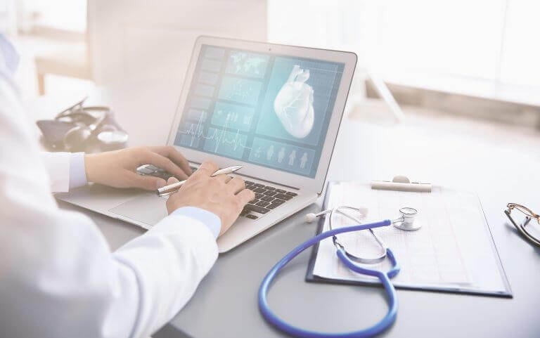 doctor looking at a heart on a laptop