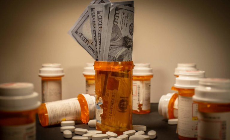 Pill bottles and money representing medicare fraud.
