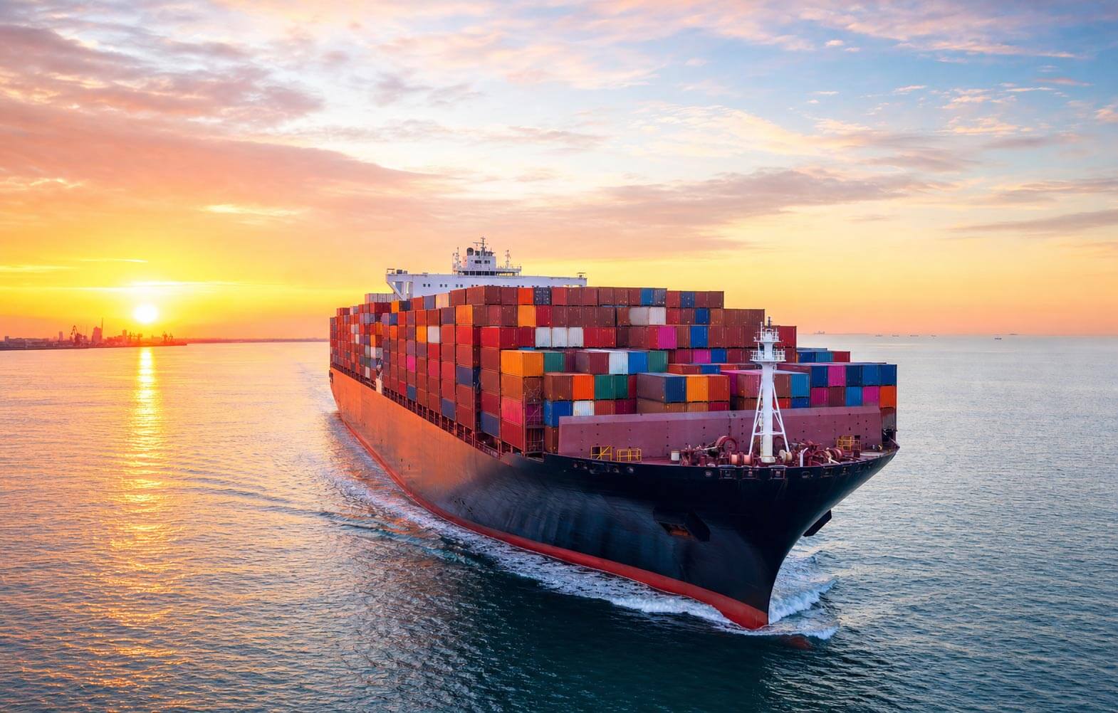 A container cargo ship at sea carrying shipping containers toward the United States